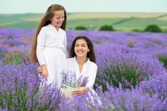 Young woman and girl are in the lavender field, beautiful summer landscape with red poppy flowers Royalty Free Stock Photo Young woman and girl are in the lavender field, beautiful summer landscape with red poppy flowers Royalty Free Stock Photo