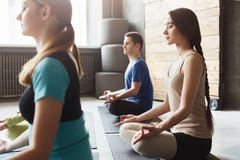 Young women and men in yoga class, relax meditation pose royalty free stock photo Young women and men in yoga class, relax meditation pose royalty free stock photo