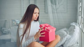 Young women is unhappy about her christmas gift and looking sad