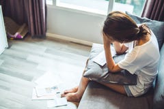 Young women worried about bills and debr stacking up. Unable to pay credit cards and loans royalty free stock photo Young women worried about bills and debr stacking up. Unable to pay credit cards and loans royalty free stock photo