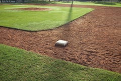 Youth baseball infield from first base side in morning light Stock Photos Youth baseball infield from first base side in morning light Stock Photos