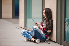Youth and technology. Attractive young woman using tablet computer outdoors. royalty free stock photography Youth and technology. Attractive young woman using tablet computer outdoors. royalty free stock photography