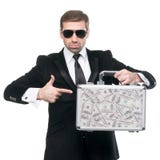 Zakenman die zijn vinger naar metaalkoffer richten Stock Foto Zakenman die zijn vinger naar metaalkoffer richten Stock Foto