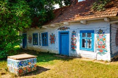 Zalipie, Poland, August 19, 2018: Colourful house with flowers painted on walls and sundial in the village of Zalipie, Poland. It royalty free stock photos Zalipie, Poland, August 19, 2018: Colourful house with flowers painted on walls and sundial in the village of Zalipie, Poland. It royalty free stock photos