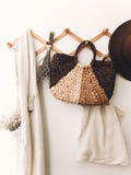 Zero waste home concept. Sustainable lifestyle. Stylish wooden hanger with straw bag, linen tote bag, brown hat and linen cloth. royalty free stock photos Zero waste home concept. Sustainable lifestyle. Stylish wooden hanger with straw bag, linen tote bag, brown hat and linen cloth. royalty free stock photos