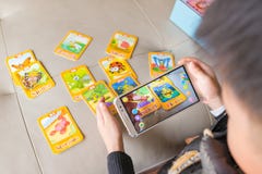 Zhongshan,China-December 30, 2017:kid playing Augmented Reality popup of cricket via mobile royalty free stock photography Zhongshan,China-December 30, 2017:kid playing Augmented Reality popup of cricket via mobile royalty free stock photography