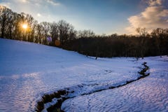 Zonsondergang over een stroom op een snow-covered gebied in landelijk Baltimore royalty-vrije stock foto's Zonsondergang over een stroom op een snow-covered gebied in landelijk Baltimore royalty-vrije stock foto's