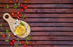 Épices, tomates-cerises, basilic et huile végétale sur la table en bois foncée, vue supérieure images stock Épices, tomates-cerises, basilic et huile végétale sur la table en bois foncée, vue supérieure images stock