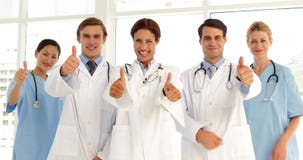 Équipe médicale sûre regardant l'appareil-photo et renonçant à des pouces banque de vidéos Équipe médicale sûre regardant l'appareil-photo et renonçant à des pouces banque de vidéos