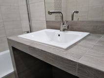Évier sur le dessus de table de la cloison sèche et carrelé, fait main salle de bains facile d'utilisation créneau dans la partie photo stock Évier sur le dessus de table de la cloison sèche et carrelé, fait main salle de bains facile d'utilisation créneau dans la partie photo stock