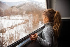 Μικρό κορίτσι στο γκρίζο πουλόβερ που ταξιδεύει με Kukushka το τραίνο στη Γεωργία και που κοιτάζει σε όλο το παράθυρο στοκ εικόνες με δικαίωμα ελεύθερης χρήσης Μικρό κορίτσι στο γκρίζο πουλόβερ που ταξιδεύει με Kukushka το τραίνο στη Γεωργία και που κοιτάζει σε όλο το παράθυρο στοκ εικόνες με δικαίωμα ελεύθερης χρήσης