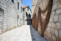 Οδός που πυροβολείται στην παλαιά πόλη Hvar, Κροατία με τα δίχτυα του ψαρέματος στοκ εικόνα με δικαίωμα ελεύθερης χρήσης Οδός που πυροβολείται στην παλαιά πόλη Hvar, Κροατία με τα δίχτυα του ψαρέματος στοκ εικόνα με δικαίωμα ελεύθερης χρήσης