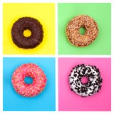 Τέσσερα διαφορετικά donuts στη φωτεινή πολύχρωμη τοπ άποψη υποβάθρου στοκ φωτογραφία με δικαίωμα ελεύθερης χρήσης Τέσσερα διαφορετικά donuts στη φωτεινή πολύχρωμη τοπ άποψη υποβάθρου στοκ φωτογραφία με δικαίωμα ελεύθερης χρήσης