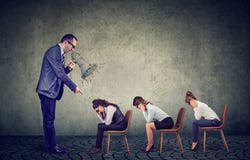 Сердитый босс кричащий в мегафоне давая заказы грустный смотреть вниз с женских работников стоковая фотография rf Сердитый босс кричащий в мегафоне давая заказы грустный смотреть вниз с женских работников стоковая фотография rf