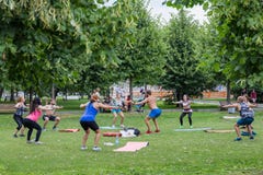 Спорт outdoors Группа людей делая тренировки в парке стоковые фотографии rf Спорт outdoors Группа людей делая тренировки в парке стоковые фотографии rf