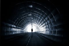 Темный тоннель с идя женщиной стоковые фотографии rf Темный тоннель с идя женщиной стоковые фотографии rf