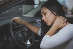 Żeński kierowca naciera jej bolącą szyję po długiej przejażdżki obrazy stock Żeński kierowca naciera jej bolącą szyję po długiej przejażdżki obrazy stock