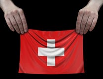 Άτομο που κρατά την ελβετική σημαία Στοκ Εικόνες Άτομο που κρατά την ελβετική σημαία Στοκ Εικόνες
