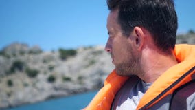 Ένα άτομο στα πανιά ζωής σακακιών σε μια βάρκα κατά μήκος της ακτής HD, 1920x1080 κίνηση αργή απόθεμα βίντεο Ένα άτομο στα πανιά ζωής σακακιών σε μια βάρκα κατά μήκος της ακτής HD, 1920x1080 κίνηση αργή απόθεμα βίντεο