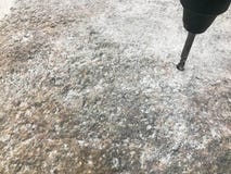 Ένα εύρωστο, σκληρό κομμάτι τρυπανιών σιδήρου μετάλλων τρυπά μια τρύπα σε μια μεγάλη γκρίζα πέτρα με τρυπάνι Στενή όψη εθνικό ver στοκ εικόνες Ένα εύρωστο, σκληρό κομμάτι τρυπανιών σιδήρου μετάλλων τρυπά μια τρύπα σε μια μεγάλη γκρίζα πέτρα με τρυπάνι Στενή όψη εθνικό ver στοκ εικόνες