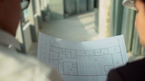 Αρσενικοί και θηλυκοί εκτελεστικοί μηχανικοί στα σκληρά καπέλα που περπατούν γύρω από το εργαστήριο εργοστασίων και που συζητούν φιλμ μικρού μήκους Αρσενικοί και θηλυκοί εκτελεστικοί μηχανικοί στα σκληρά καπέλα που περπατούν γύρω από το εργαστήριο εργοστασίων και που συζητούν φιλμ μικρού μήκους