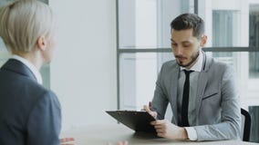 Αρσενικός διευθυντής ωρ. που έχει τη συνέντευξη εργασίας με τη νέα γυναίκα στο κοστούμι και που προσέχει την αίτηση περιλήψεών τη Αρσενικός διευθυντής ωρ. που έχει τη συνέντευξη εργασίας με τη νέα γυναίκα στο κοστούμι και που προσέχει την αίτηση περιλήψεών τη