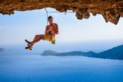Αρσενικός ορειβάτης στη overhanging αψίδα βράχου, όμορφη άποψη της ακτής β Στοκ Φωτογραφίες Αρσενικός ορειβάτης στη overhanging αψίδα βράχου, όμορφη άποψη της ακτής β Στοκ Φωτογραφίες
