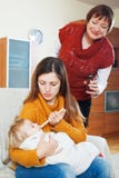 Γυναίκα με την ώριμη μητέρα που φροντίζει για το άρρωστο μωρό στοκ εικόνα με δικαίωμα ελεύθερης χρήσης Γυναίκα με την ώριμη μητέρα που φροντίζει για το άρρωστο μωρό στοκ εικόνα με δικαίωμα ελεύθερης χρήσης