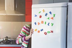 Γυναίκα που κοιτάζει στο ανοικτό ψυγείο με τις οικογενειακές επιστολές Στοκ Εικόνα Γυναίκα που κοιτάζει στο ανοικτό ψυγείο με τις οικογενειακές επιστολές Στοκ Εικόνα