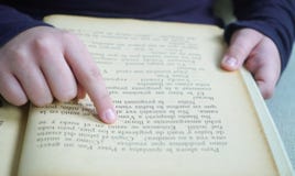 δάχτυλο ενός κοριτσιού σε ένα βιβλίο στοκ φωτογραφία δάχτυλο ενός κοριτσιού σε ένα βιβλίο στοκ φωτογραφία