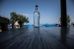 Διαφανές μπουκάλι με το υπόβαθρο νερού και ουρανού στοκ εικόνες Διαφανές μπουκάλι με το υπόβαθρο νερού και ουρανού στοκ εικόνες