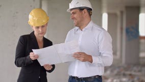 Δύο αρχιτέκτονες που φορούν τις προστατευτικές εργασίες κρανών στο εργοτάξιο στοκ φωτογραφία με δικαίωμα ελεύθερης χρήσης Δύο αρχιτέκτονες που φορούν τις προστατευτικές εργασίες κρανών στο εργοτάξιο στοκ φωτογραφία με δικαίωμα ελεύθερης χρήσης