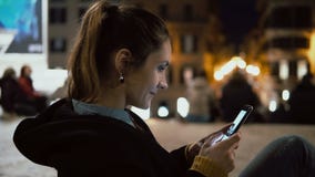 Ελκυστική συνεδρίαση γυναικών brunette στο κέντρο της πόλης να εξισώσει και να φανεί φωτογραφία στο smartphone με την τεχνολογία απόθεμα βίντεο Ελκυστική συνεδρίαση γυναικών brunette στο κέντρο της πόλης να εξισώσει και να φανεί φωτογραφία στο smartphone με την τεχνολογία απόθεμα βίντεο