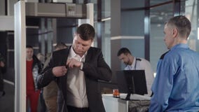 Επιχειρηματίας που περνά το συνοριακό έλεγχο με το ανιχνευτή μετάλλων φιλμ μικρού μήκους Επιχειρηματίας που περνά το συνοριακό έλεγχο με το ανιχνευτή μετάλλων φιλμ μικρού μήκους