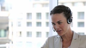 Επιχειρησιακή γυναίκα που γελά μιλώντας σε μια κάσκα απόθεμα βίντεο Επιχειρησιακή γυναίκα που γελά μιλώντας σε μια κάσκα απόθεμα βίντεο
