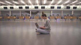 Εργασία γυναικών για το lap-top και αναμονή την πτήση στον αερολιμένα στο τερματικό στο πάτωμα απόθεμα βίντεο Εργασία γυναικών για το lap-top και αναμονή την πτήση στον αερολιμένα στο τερματικό στο πάτωμα απόθεμα βίντεο