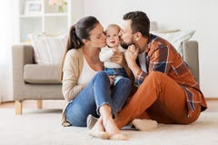 Ευτυχές φιλώντας μωρό μητέρων και πατέρων στο σπίτι στοκ φωτογραφία με δικαίωμα ελεύθερης χρήσης Ευτυχές φιλώντας μωρό μητέρων και πατέρων στο σπίτι στοκ φωτογραφία με δικαίωμα ελεύθερης χρήσης
