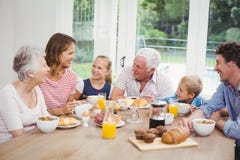 Ευτυχής multi-generation οικογένεια που έχει το πρόγευμα στοκ εικόνα Ευτυχής multi-generation οικογένεια που έχει το πρόγευμα στοκ εικόνα