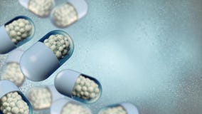 Ζωηρόχρωμες αφηρημένες χαοτικές σφαίρες δομών μέσα στην κάψα, το φαρμακείο και την ιατρική έννοια στοκ φωτογραφίες Ζωηρόχρωμες αφηρημένες χαοτικές σφαίρες δομών μέσα στην κάψα, το φαρμακείο και την ιατρική έννοια στοκ φωτογραφίες