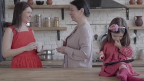 Η γιαγιά, η μητέρα και λίγη κόρη είναι μαζί σε μια σύγχρονη κουζίνα Η συνεδρίαση ταμπλετών εκμετάλλευσης κοριτσιών στον πίνακα απόθεμα βίντεο Η γιαγιά, η μητέρα και λίγη κόρη είναι μαζί σε μια σύγχρονη κουζίνα Η συνεδρίαση ταμπλετών εκμετάλλευσης κοριτσιών στον πίνακα απόθεμα βίντεο