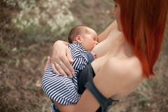 Η ευτυχής νέα μητέρα θηλάζει το νεογέννητο μωρό στον περίπατο στοκ φωτογραφία με δικαίωμα ελεύθερης χρήσης Η ευτυχής νέα μητέρα θηλάζει το νεογέννητο μωρό στον περίπατο στοκ φωτογραφία με δικαίωμα ελεύθερης χρήσης