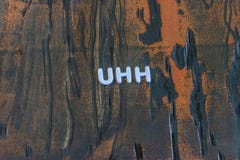 Η λέξη uhh που γράφεται στα άσπρα κεφαλαία γράμματα στοκ εικόνες Η λέξη uhh που γράφεται στα άσπρα κεφαλαία γράμματα στοκ εικόνες