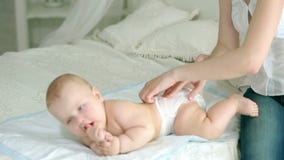 Η μητέρα ντύνει το νήπιο Μια νέα μητέρα και ένα εξάμηνο παιδί Το Mom φορά τις πάνες, τα τζιν και ένα πουκάμισο, κάλτσες Ένα παιδί απόθεμα βίντεο Η μητέρα ντύνει το νήπιο Μια νέα μητέρα και ένα εξάμηνο παιδί Το Mom φορά τις πάνες, τα τζιν και ένα πουκάμισο, κάλτσες Ένα παιδί απόθεμα βίντεο