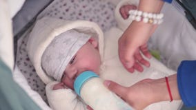 Η μητέρα ταΐζει το γάλα παιδιών μικρών παιδιών αγοράκι από ένα πλαστικό μπουκάλι με μια φωτεινή μπλε θηλή - καυκάσιο λευκό παιδί απόθεμα βίντεο Η μητέρα ταΐζει το γάλα παιδιών μικρών παιδιών αγοράκι από ένα πλαστικό μπουκάλι με μια φωτεινή μπλε θηλή - καυκάσιο λευκό παιδί απόθεμα βίντεο