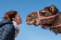 Η νέα γυναίκα έπεσε ερωτευμένη με dromedary στο Μαρόκο στοκ εικόνα με δικαίωμα ελεύθερης χρήσης Η νέα γυναίκα έπεσε ερωτευμένη με dromedary στο Μαρόκο στοκ εικόνα με δικαίωμα ελεύθερης χρήσης
