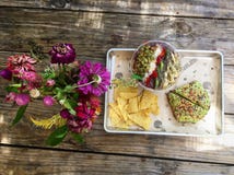 Η υγιής vegan φρυγανιά αβοκάντο κατανάλωσης πελεκά τα λουλούδια στοκ εικόνες Η υγιής vegan φρυγανιά αβοκάντο κατανάλωσης πελεκά τα λουλούδια στοκ εικόνες