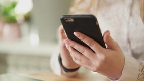 Κλείστε αυξημένος ενός νέου κοριτσιού δίνει, το οποίο κρατώντας ένα smartphone απόθεμα βίντεο Κλείστε αυξημένος ενός νέου κοριτσιού δίνει, το οποίο κρατώντας ένα smartphone απόθεμα βίντεο