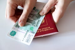 Καλλιεργημένα θηλυκά χέρια που κρατούν τα ρωσικά διεθνή χρήματα διαβατηρίων και εγγράφου, ρούβλια στοκ εικόνα Καλλιεργημένα θηλυκά χέρια που κρατούν τα ρωσικά διεθνή χρήματα διαβατηρίων και εγγράφου, ρούβλια στοκ εικόνα