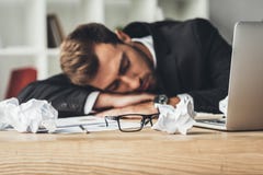 κοισμένος καταπονημένος επιχειρηματίας με τα τσαλακωμένα έγγραφα και eyeglasses Στοκ Εικόνες κοισμένος καταπονημένος επιχειρηματίας με τα τσαλακωμένα έγγραφα και eyeglasses Στοκ Εικόνες