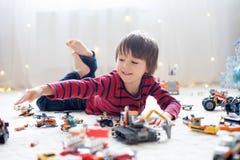 Λίγο παιδί που παίζει με τα μέρη των ζωηρόχρωμων πλαστικών παιχνιδιών εσωτερικών στοκ φωτογραφία με δικαίωμα ελεύθερης χρήσης Λίγο παιδί που παίζει με τα μέρη των ζωηρόχρωμων πλαστικών παιχνιδιών εσωτερικών στοκ φωτογραφία με δικαίωμα ελεύθερης χρήσης